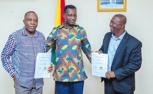 Dr Yaw Osei Adutwum (middle), Education Minister, with Edmund Poku (right), MD, Niche Cocoa Industry Limited, and Divine Ayizoe, acting Chief Director of the ministry after the signing of the memorandum of understanding in Accra
